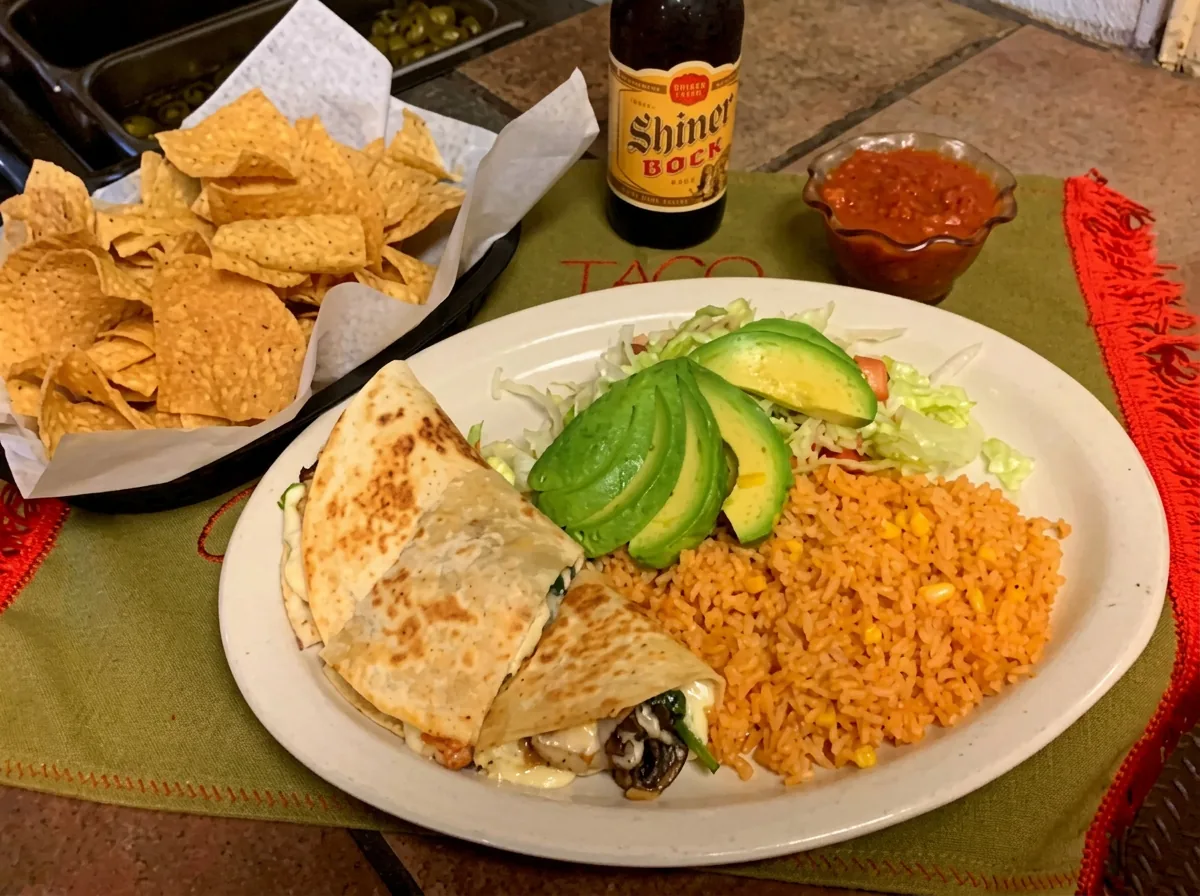 Quesadilla with sliced avocado, Mexican rice and lettuce